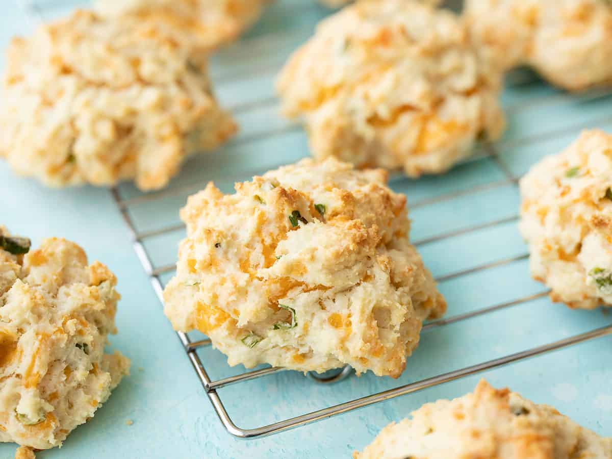 Side view of cheddar drop biscuits on the wire cooling rack