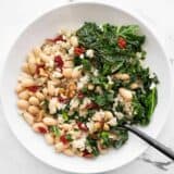 Overhead view of a Kale and White Bean Power Bowl with a fork in the side