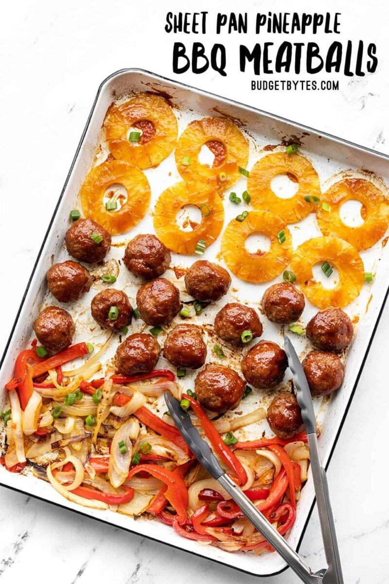 BBQ Meatballs, pineapple, peppers, and onions on a sheet pan with tongs, title text at the top