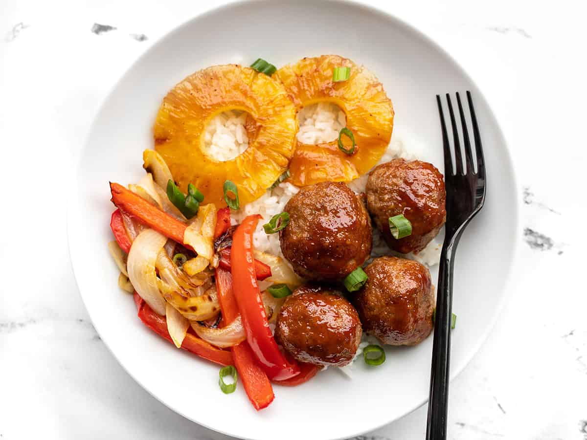 Sheet pan bbq meatballs in a bowl with pineapple, onions and peppers, and rice