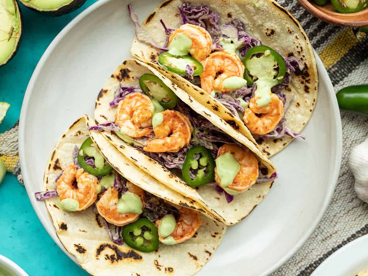 Close up of three Tajín Shrimp Tacos on a plate