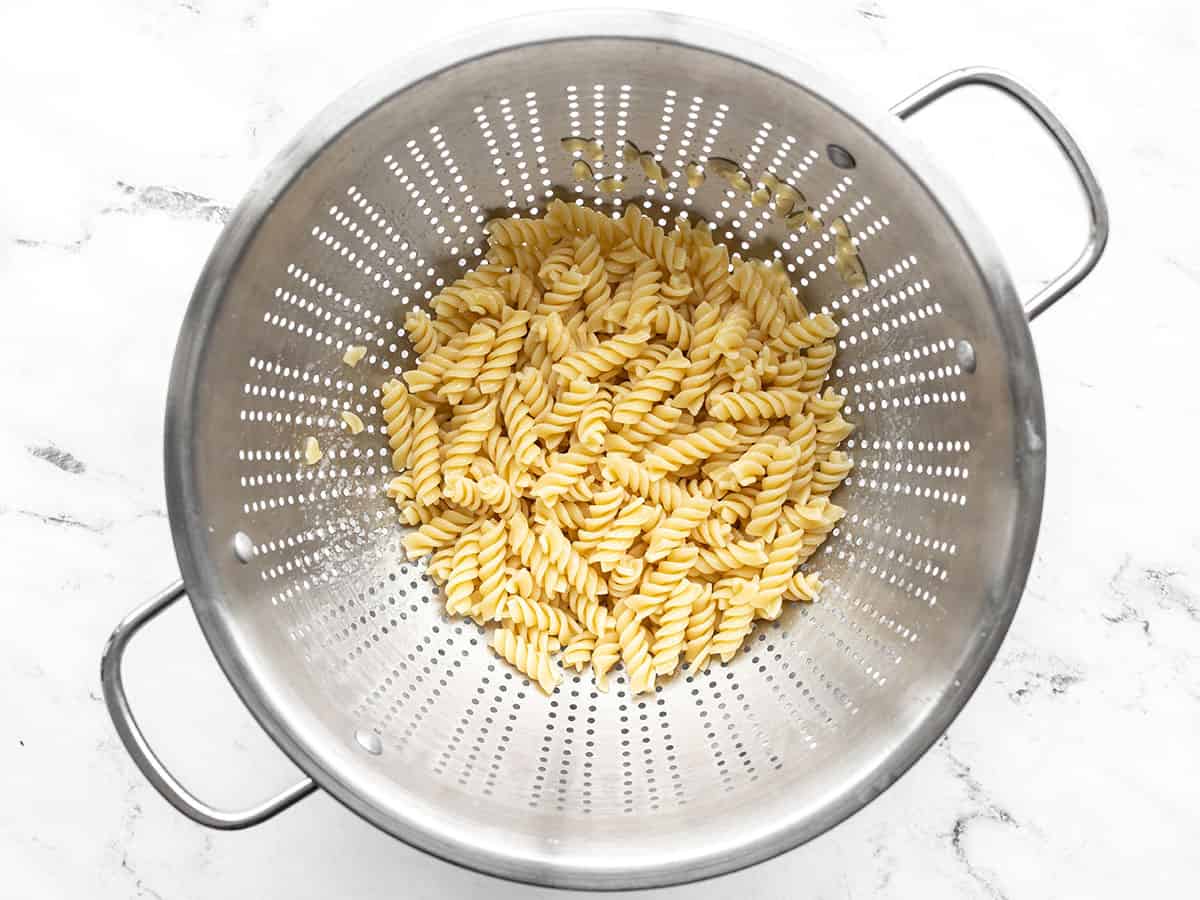 Cooked rotini in a colander