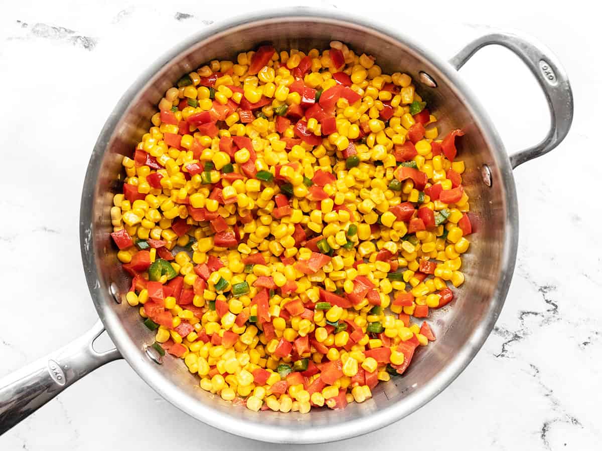 Frozen corn added to the skillet