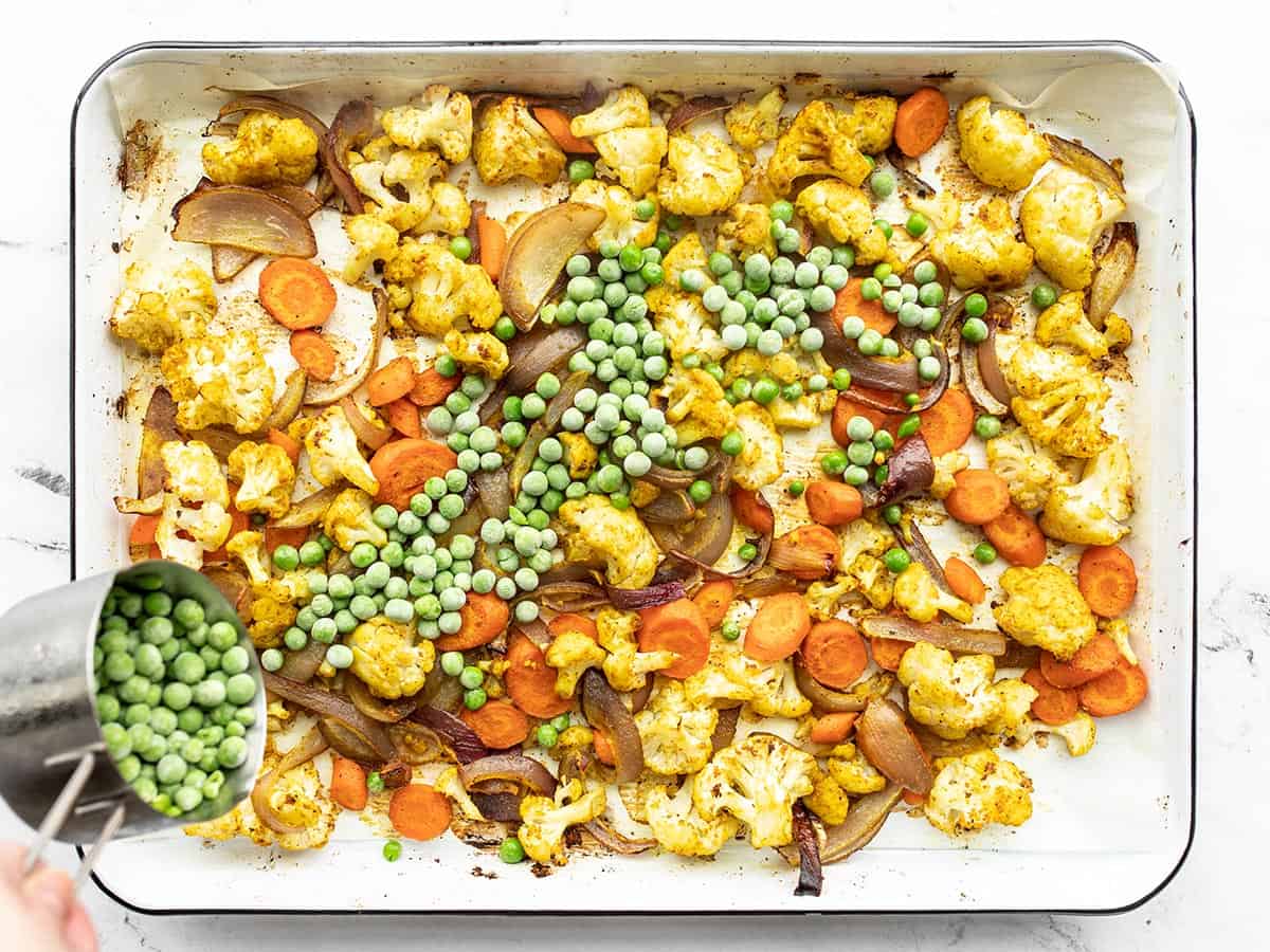 Frozen peas added to the roasted vegetables
