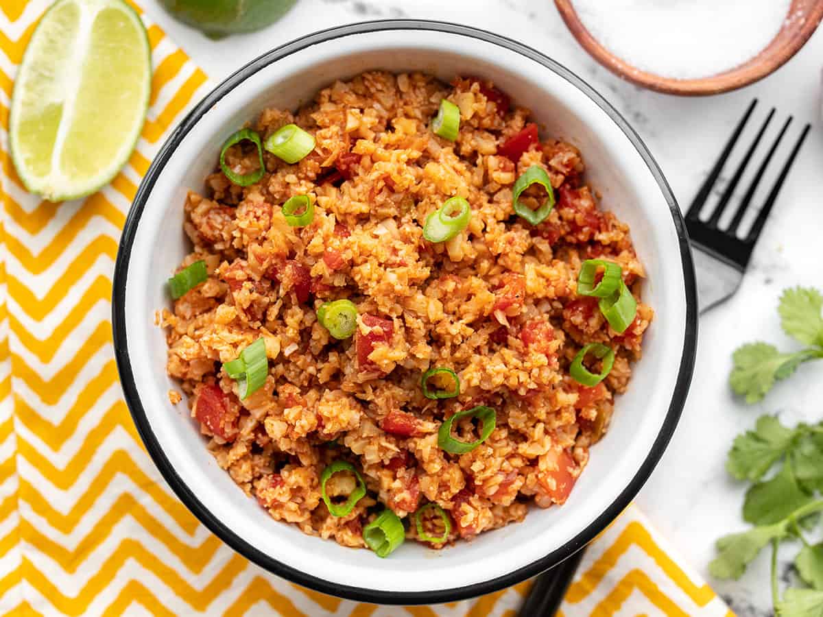 Overhead view of a bowl full of southwest cauliflower rice with a fork on the side