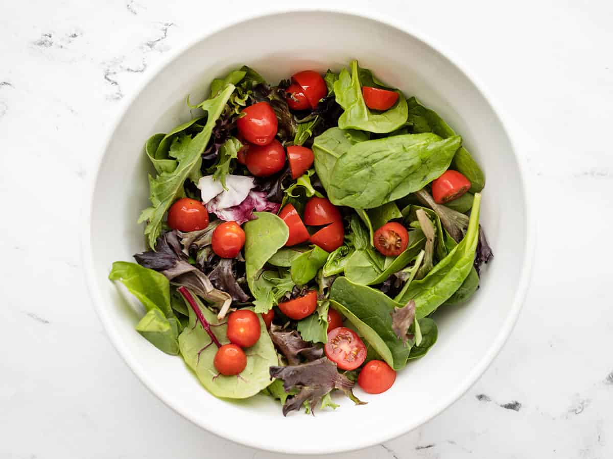 tomatoes added to the salad greens