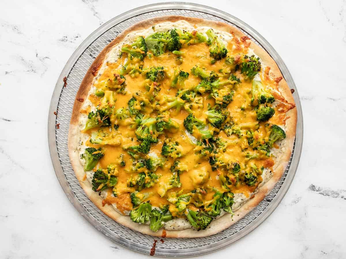 Baked broccoli cheddar pizza on the pizza pan