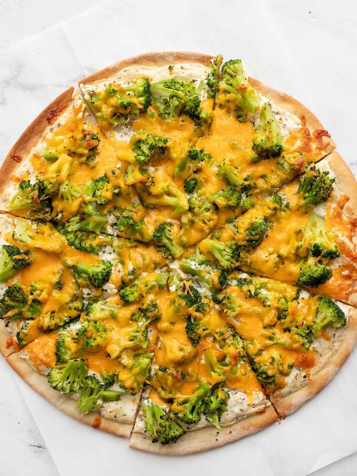 Overhead view of a broccoli cheddar pizza