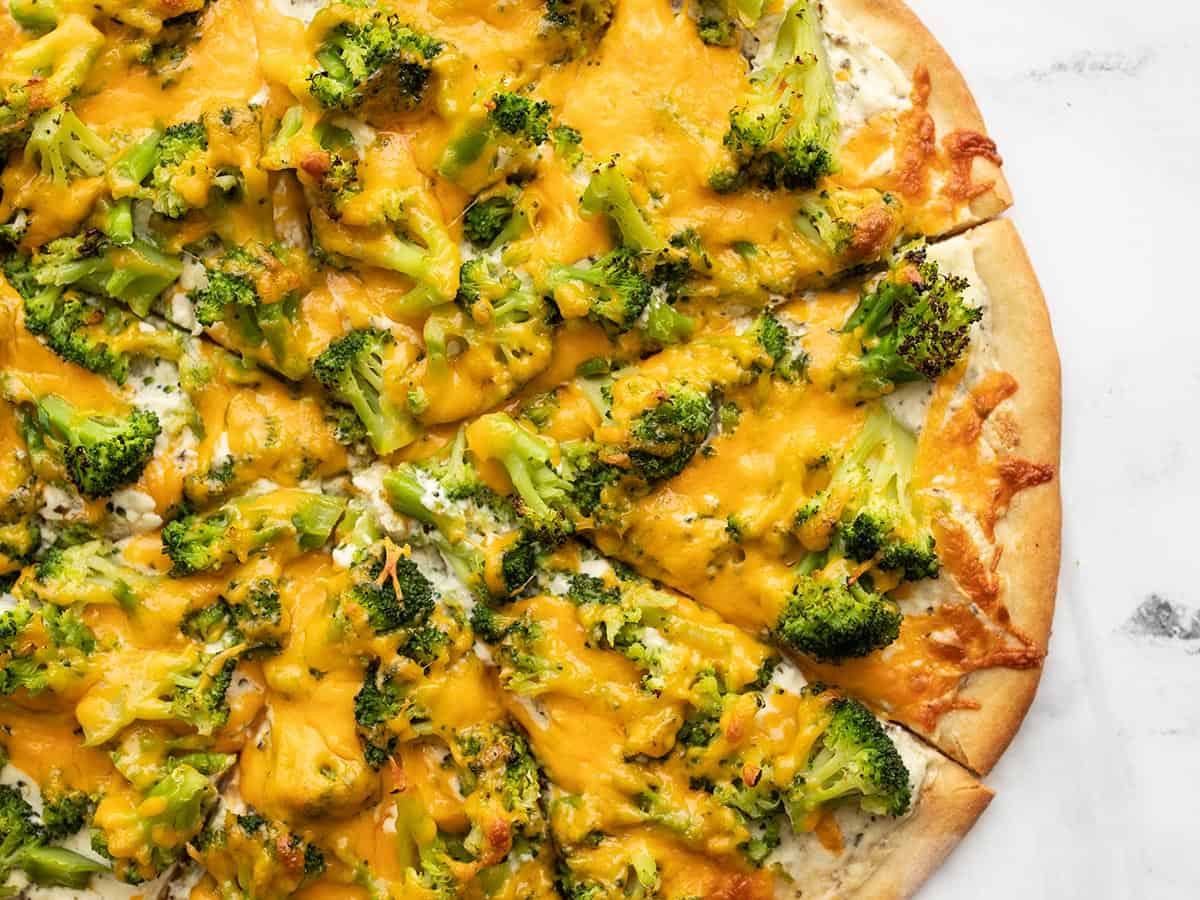 Close up of sliced broccoli cheddar pizza