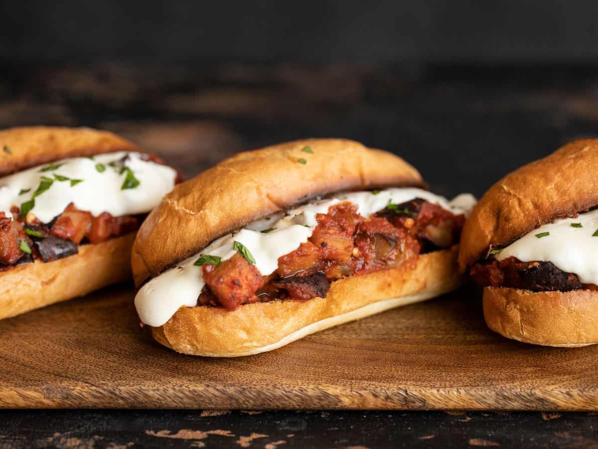 three eggplant mozzarella sandwiches in a line, angled away from the camera