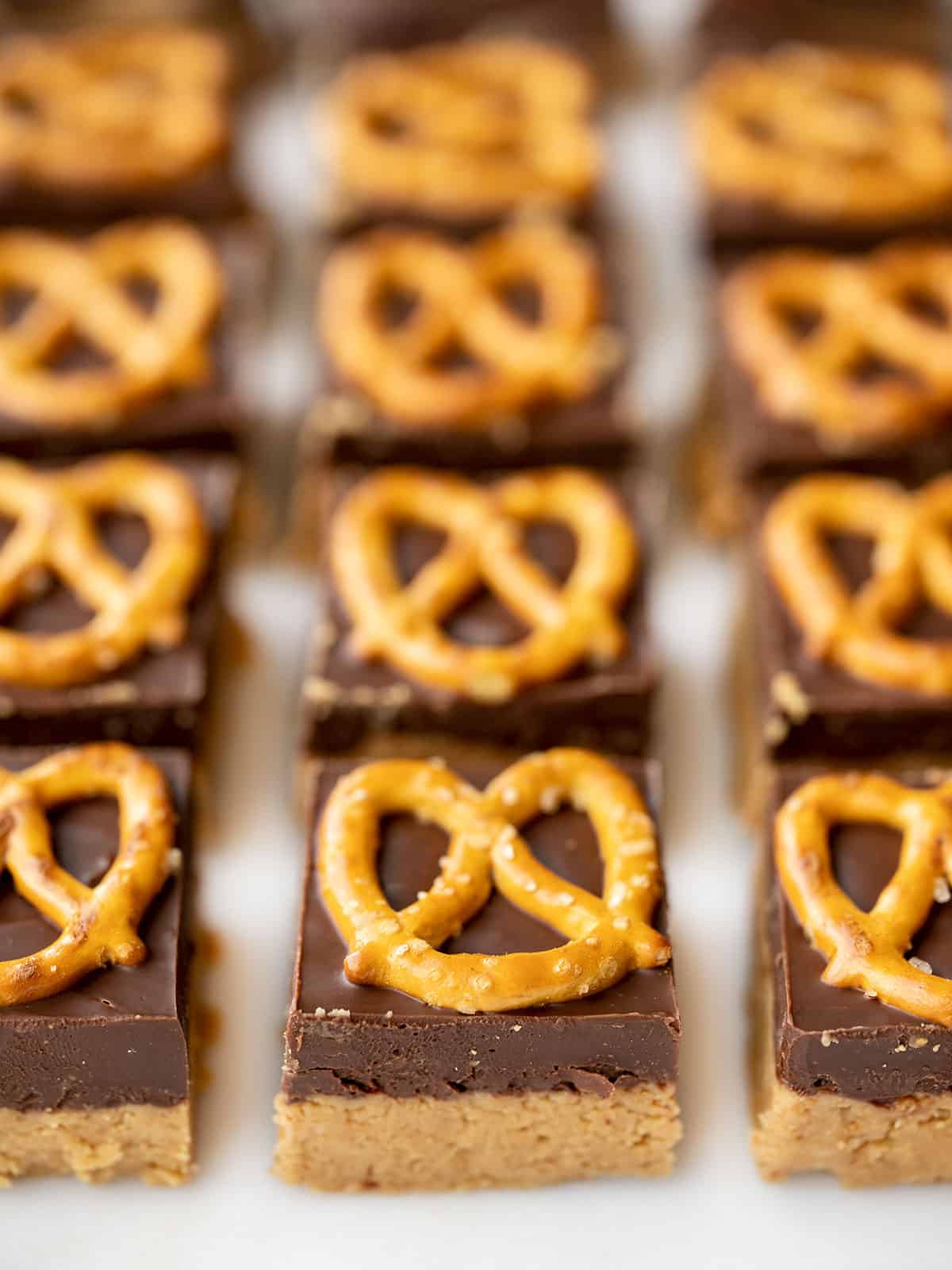 Front view of no bake pretzel peanut butter bars lined up in a grid