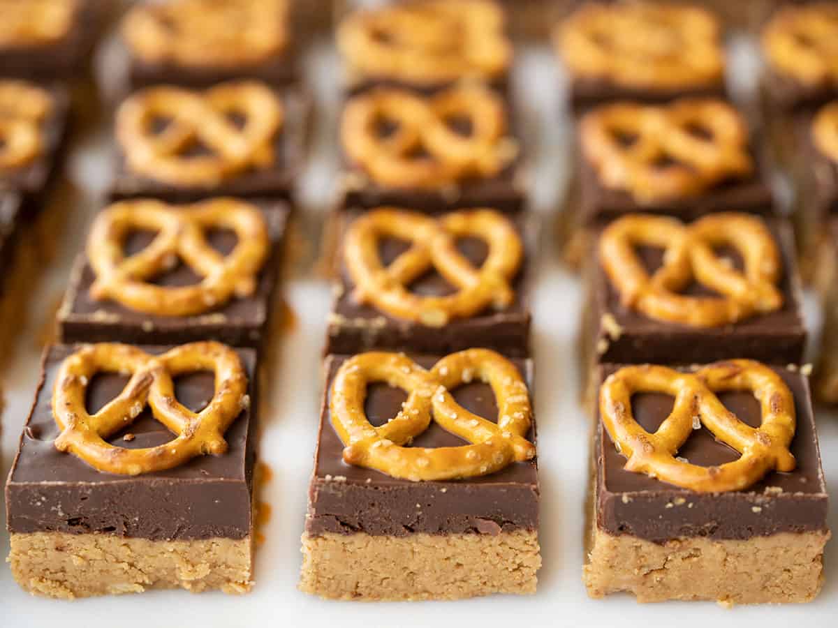 Front view of no-bake pretzel peanut butter bars lined up in a grid