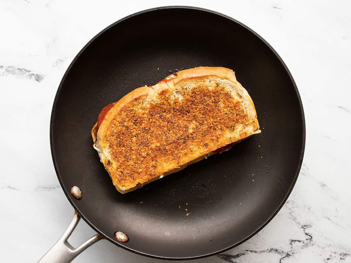 pizza melt cooking in a skillet