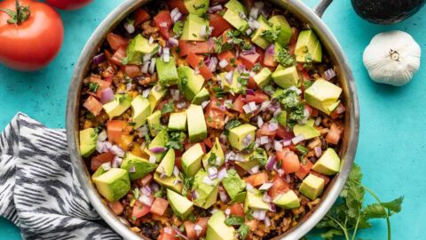 overhead view of beef and cauliflower taco skillet with vegetables on the sides