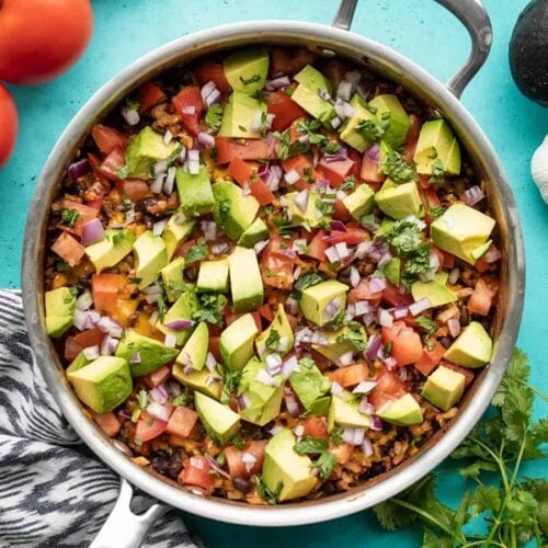 overhead view of beef and cauliflower taco skillet with vegetables on the sides