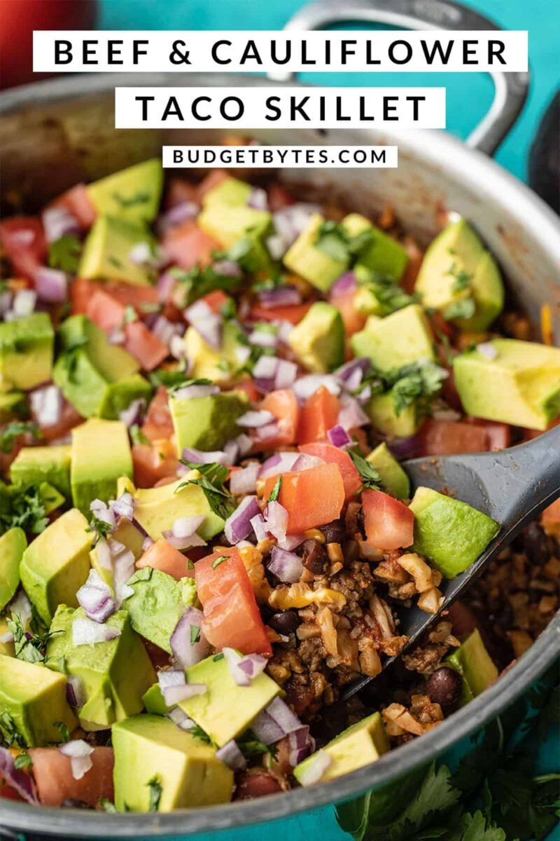 Side view of a spatula scooping beef and cauliflower taco skillet