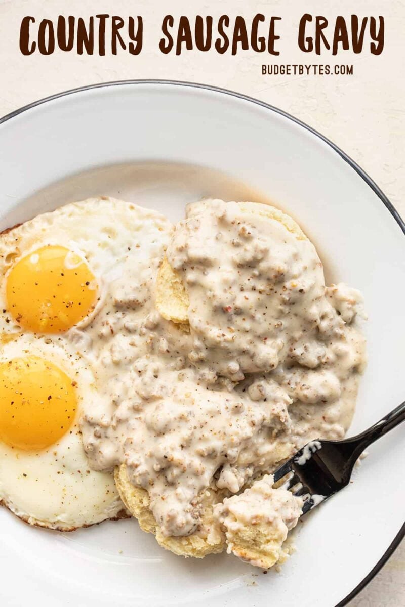 Biscuits and gravy on a plate with eggs, title text at the top