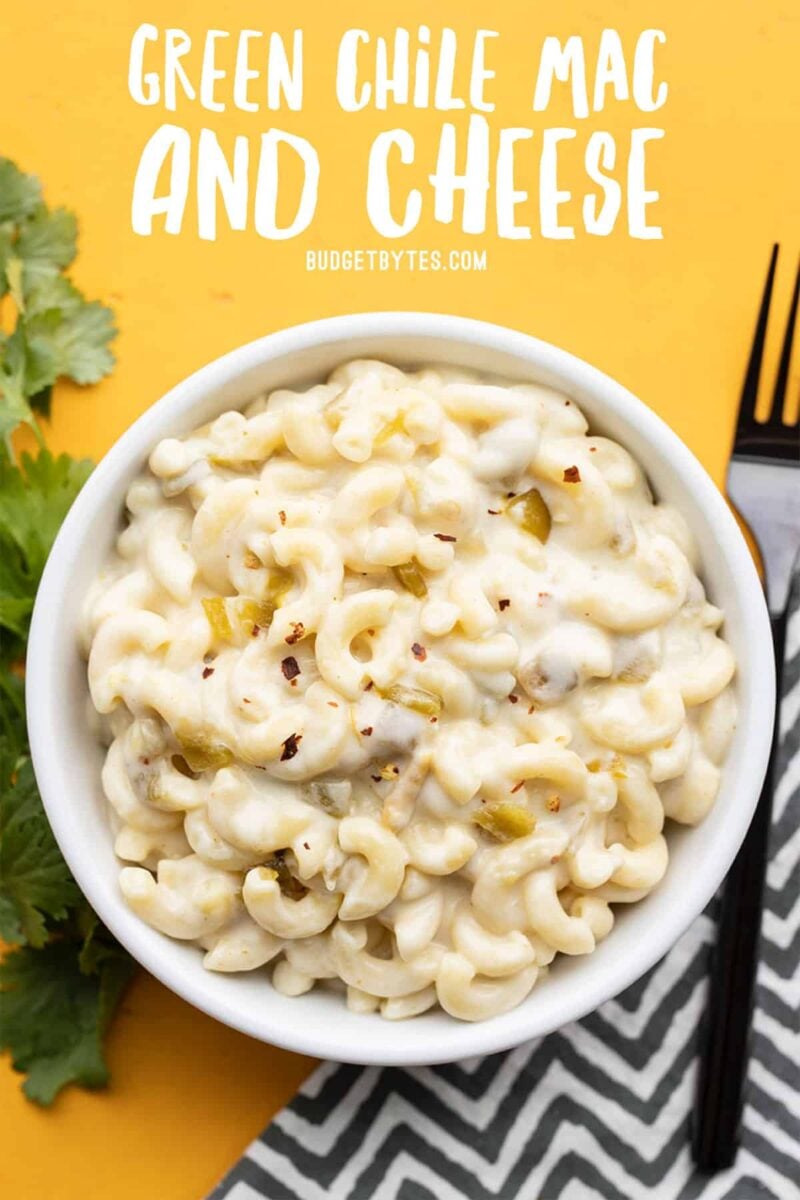 Green chile mac and cheese in a bowl with title text at the top