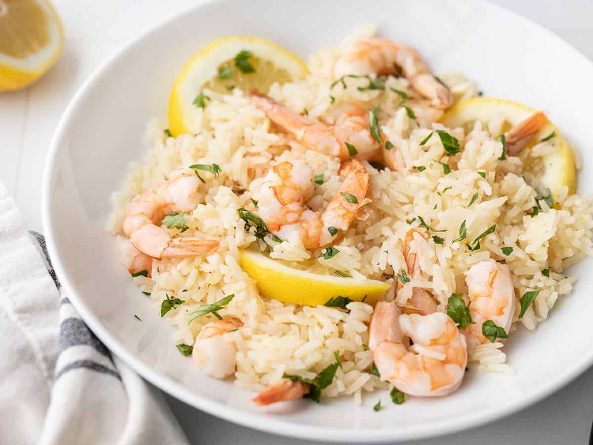 close up side view of lemon garlic shrimp and rice in a bowl