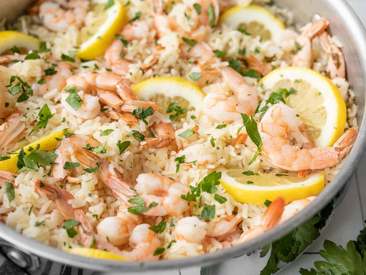 close up side view of lemon garlic shrimp and rice in the skillet