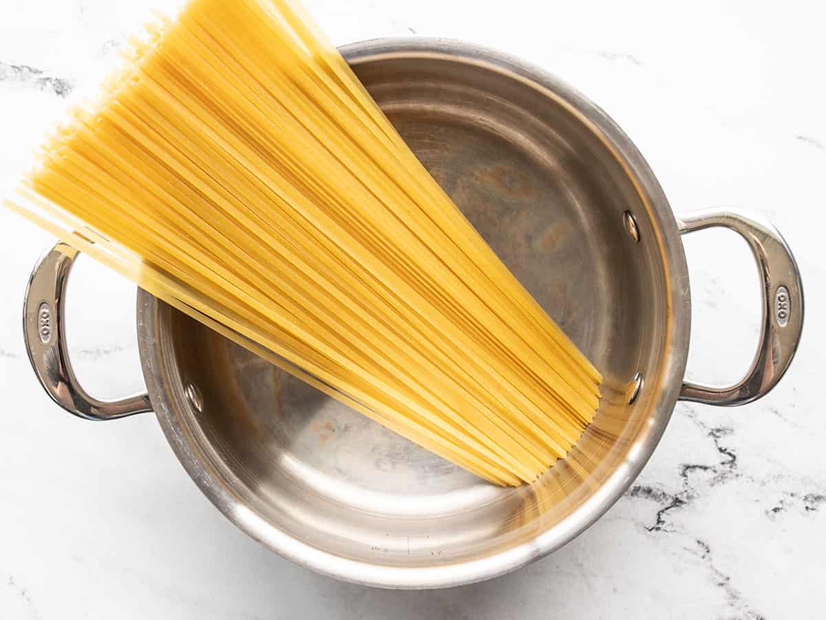 Uncooked linguine in a pot