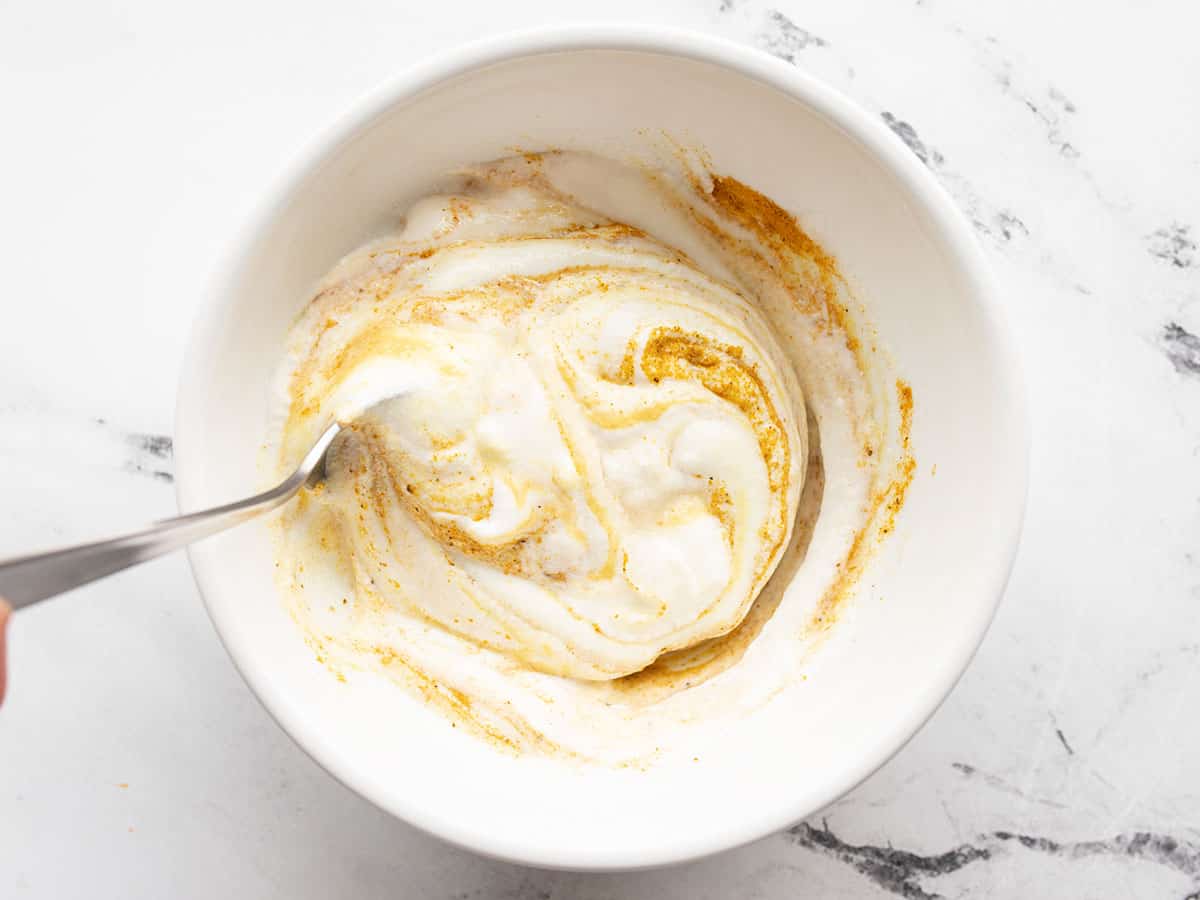 Yogurt curry sauce being stirred together