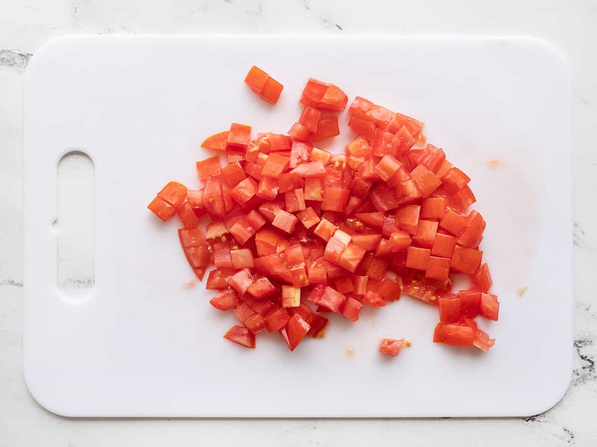 Diced roma tomatoes on a cutting board