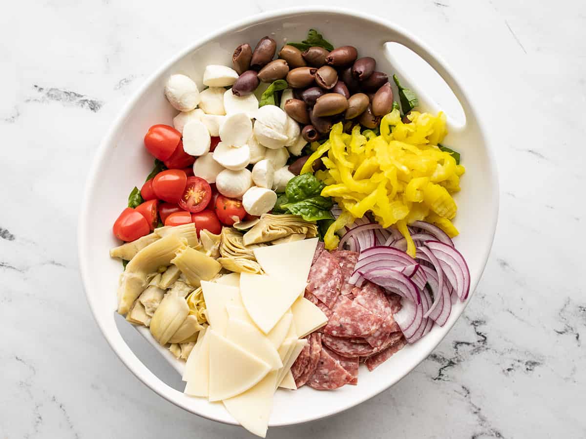 provolone, olives, peppers, and artichokes added to the salad bowl