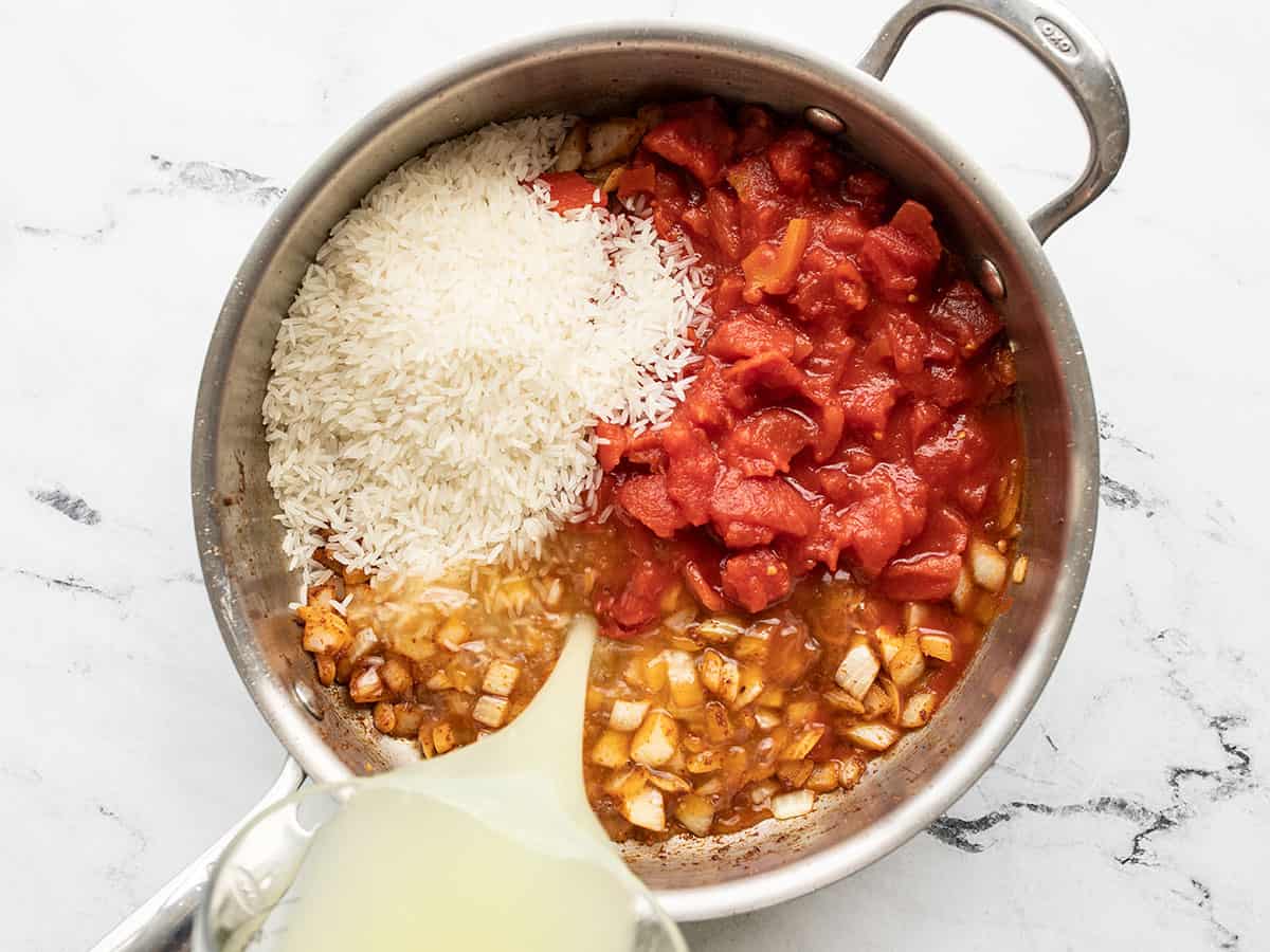 diced tomatoes, rice, and broth added to the skillet