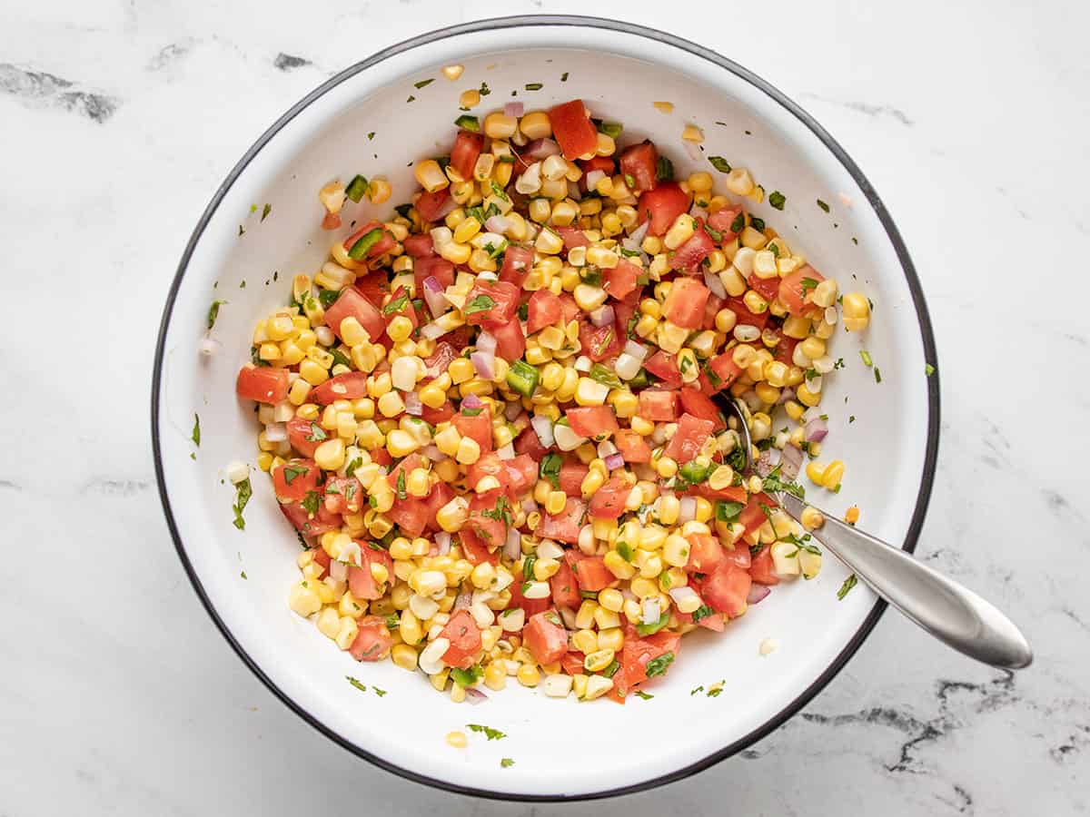 Stirred fresh corn salsa in the bowl