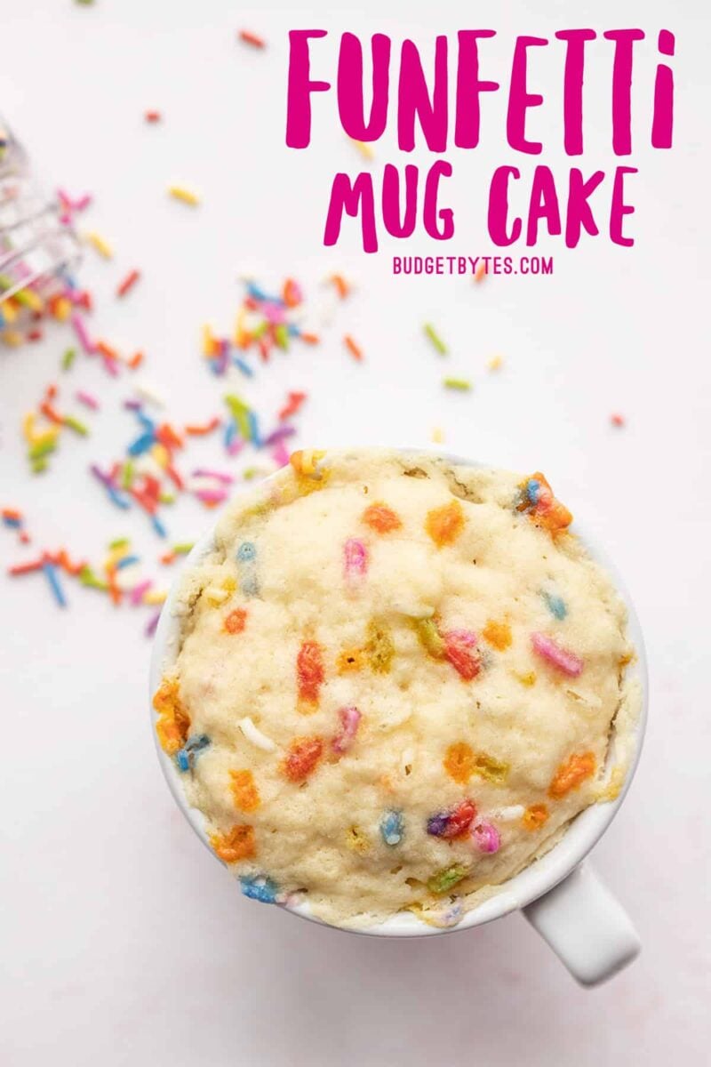 Overhead view of a funfetti mug cake, no frosting, title text at the top