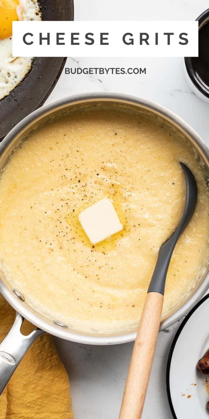 Cheese grits in a pot with melted butter and pepper, title text at the top