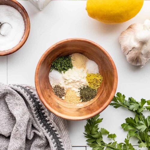 ranch seasoning mix ingredients in a wooden bowl with ingredients on the sides