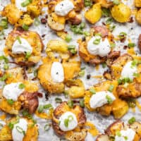 overhead view of loaded smashed potatoes on the baking sheet