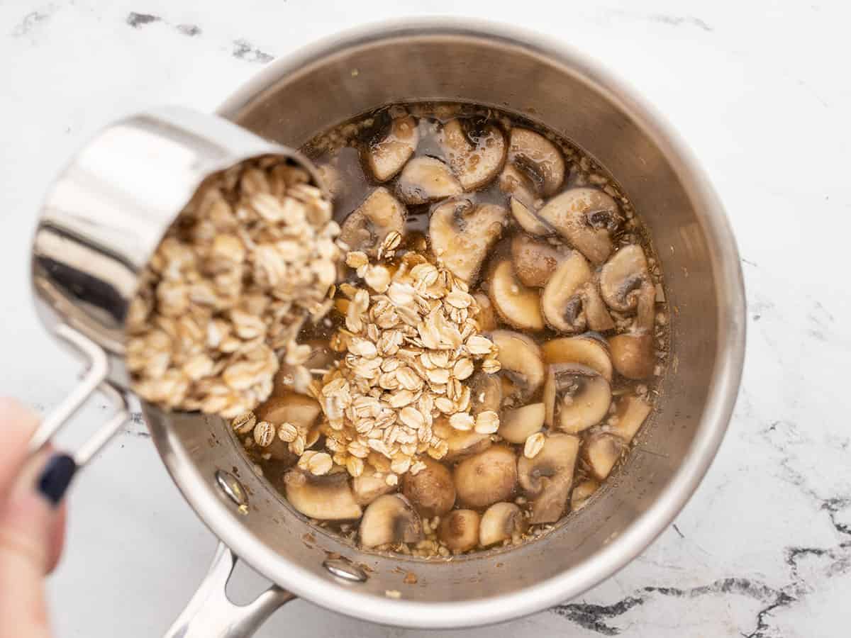 Oats being poured into the saucepot