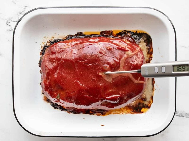 baked meatloaf with a meat thermometer inside
