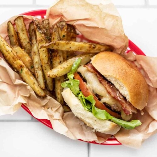 a bacon ranch turkey burger in a basket with fries