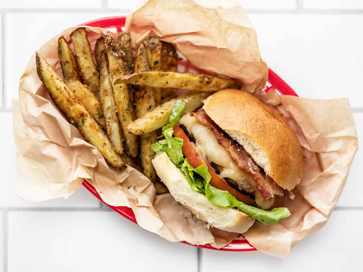 a bacon ranch turkey burger in a basket with fries