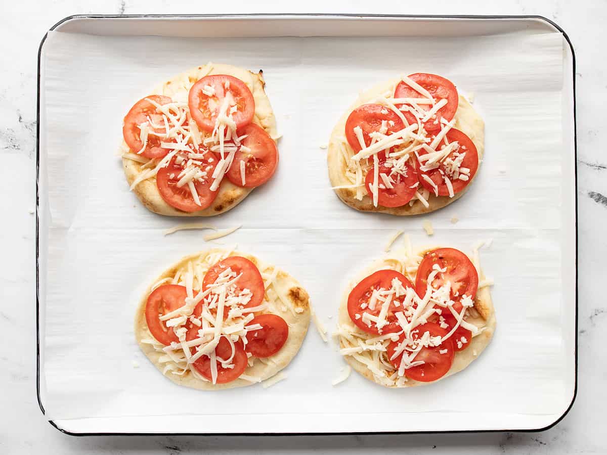 Topped pizzas on the baking sheet