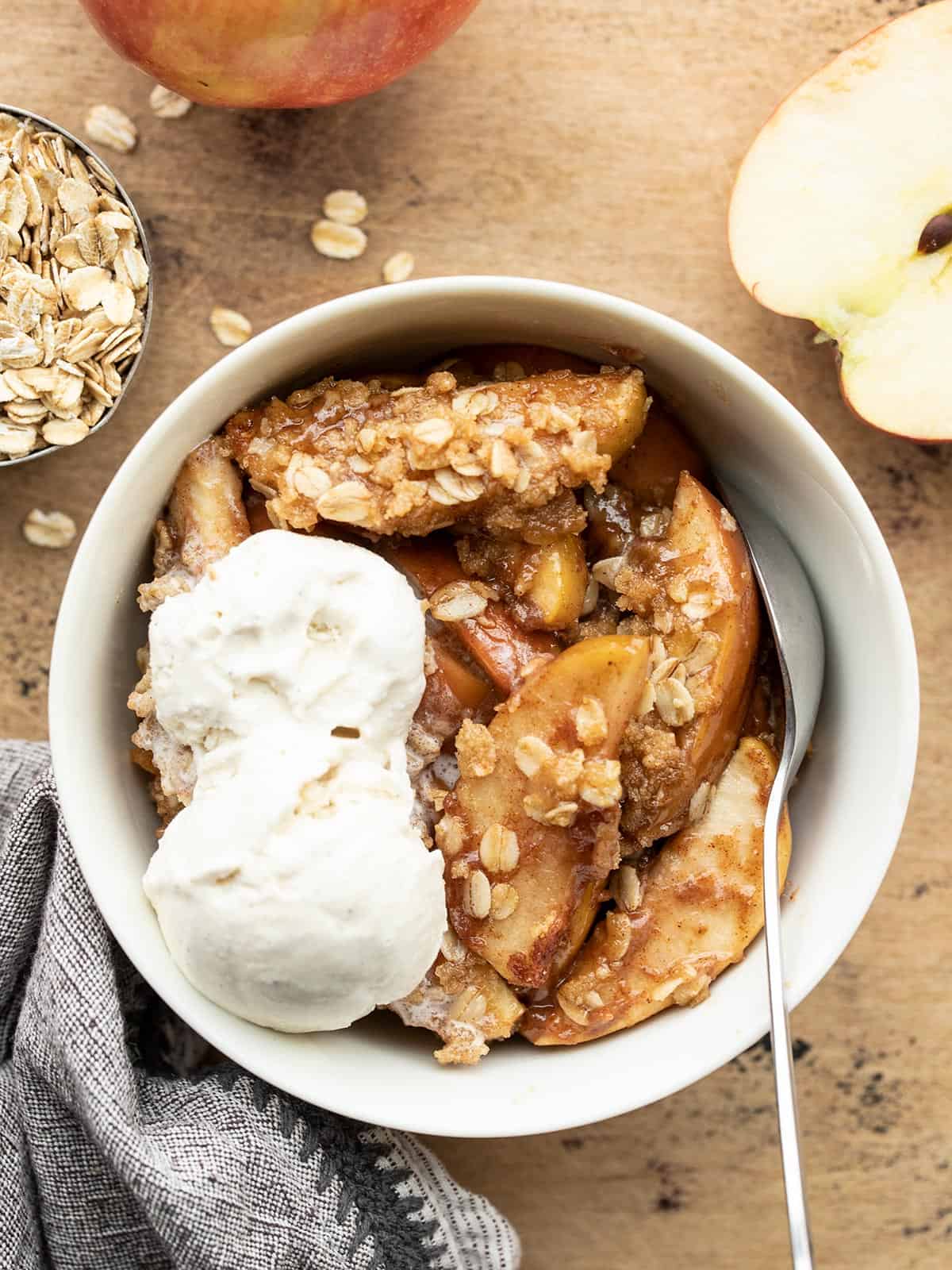 Overhead view of a bowl of apple crisp with ice cream