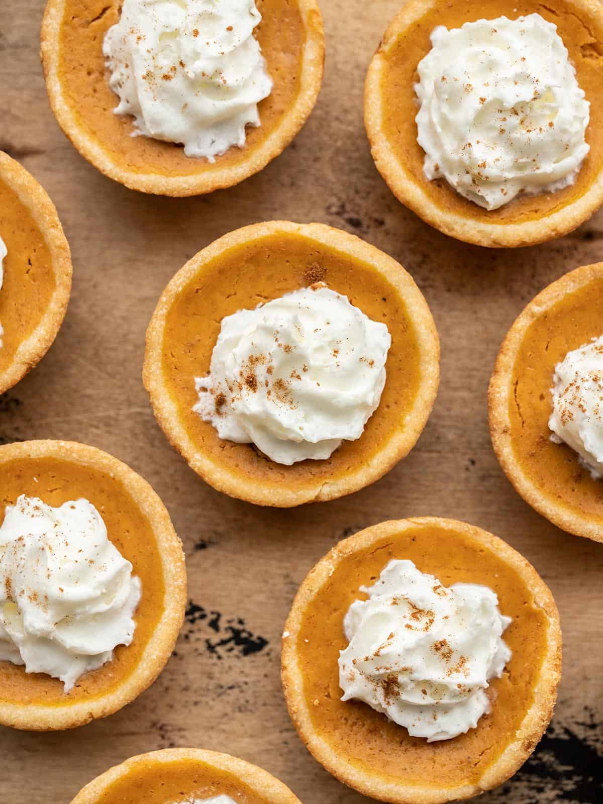 close up image of mini pumpkin pies with whipped cream