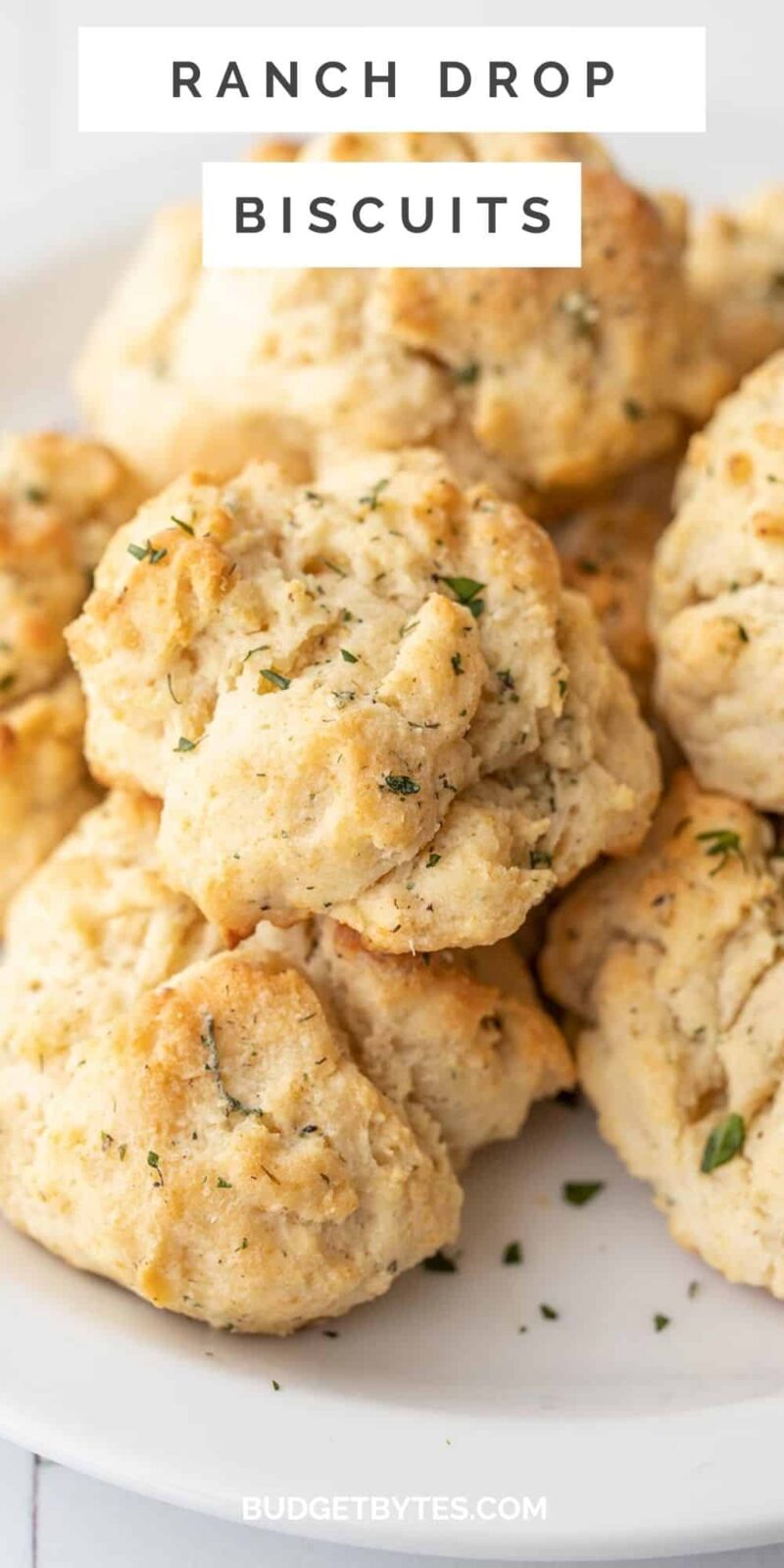 Close up side view of a plate of ranch drop biscuits, title text at the top