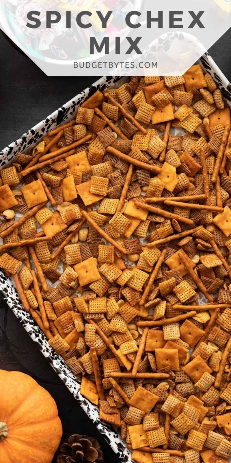 spicy chex mix on a baking sheet, title text at the top