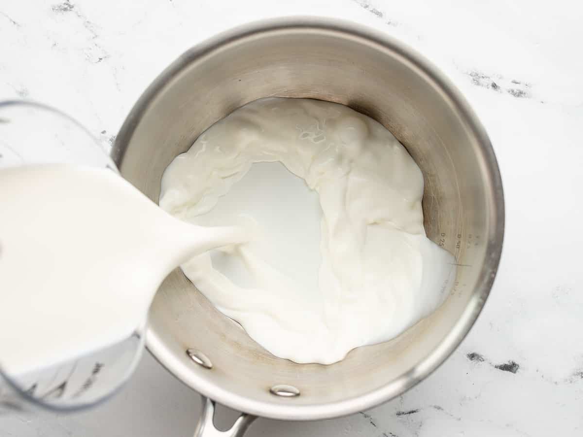 half and half being poured into a small saucepot