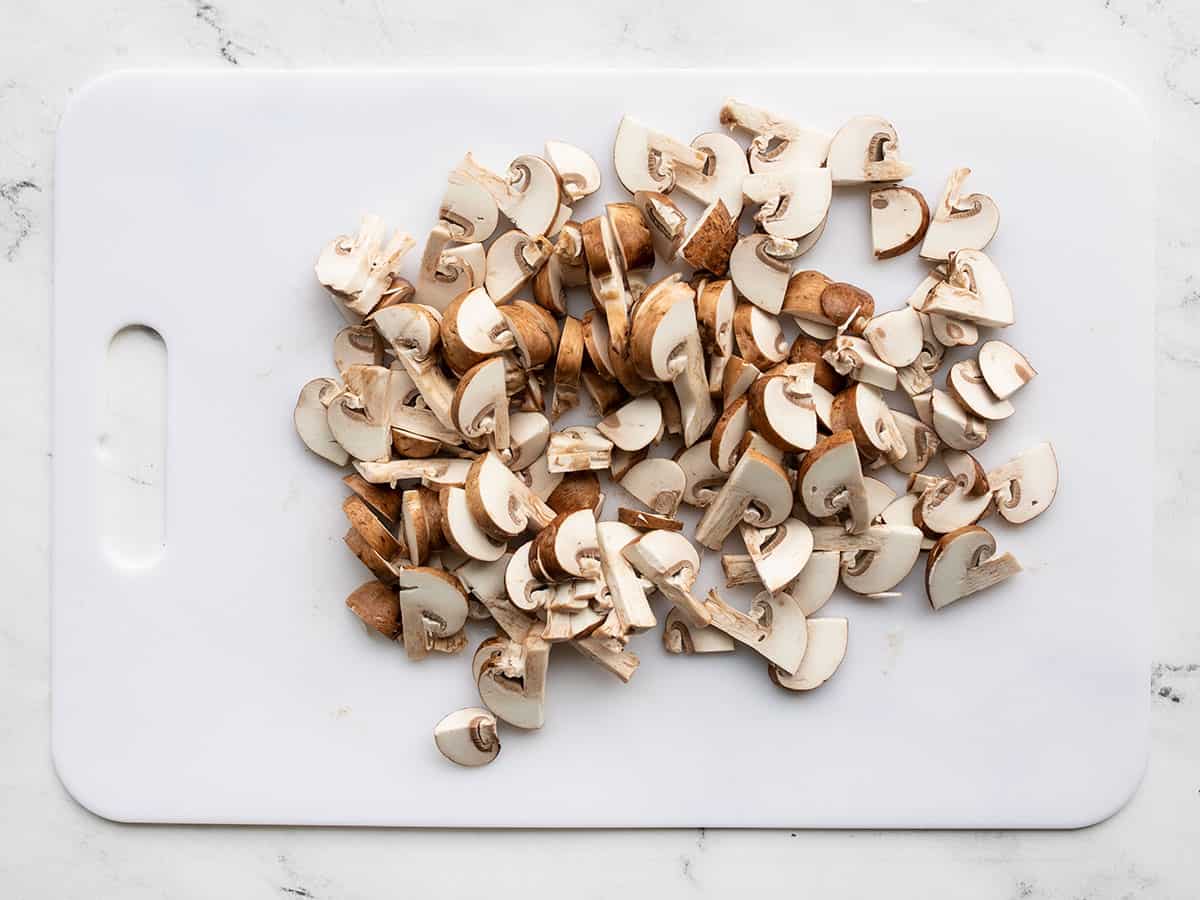 Sliced mushrooms on a cutting board