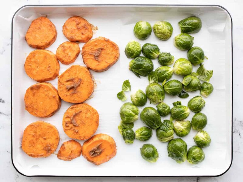 sweet potatoes and brussels sprouts on a sheet pan