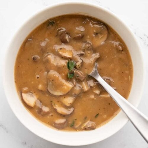 mushroom herb gravy in a bowl with a spoon