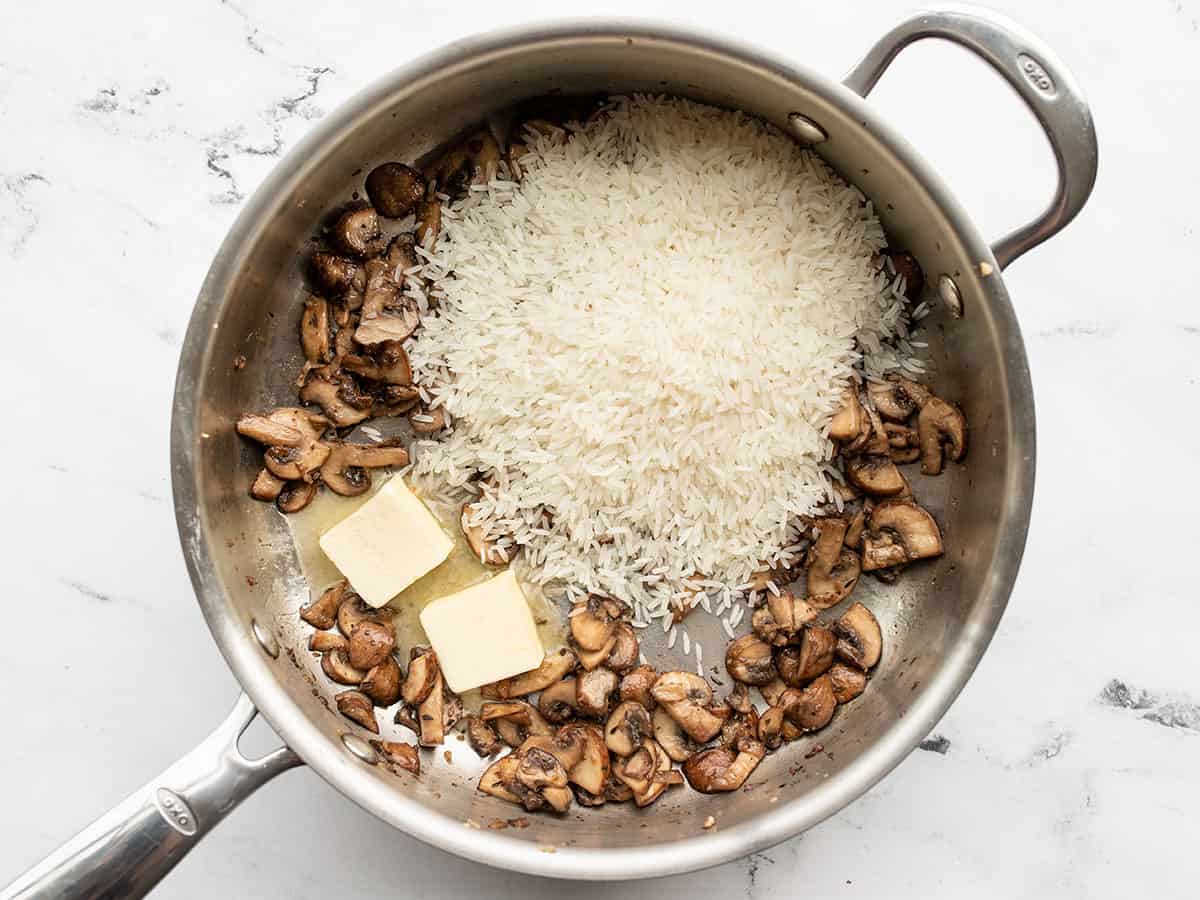 Butter and rice added to the skillet