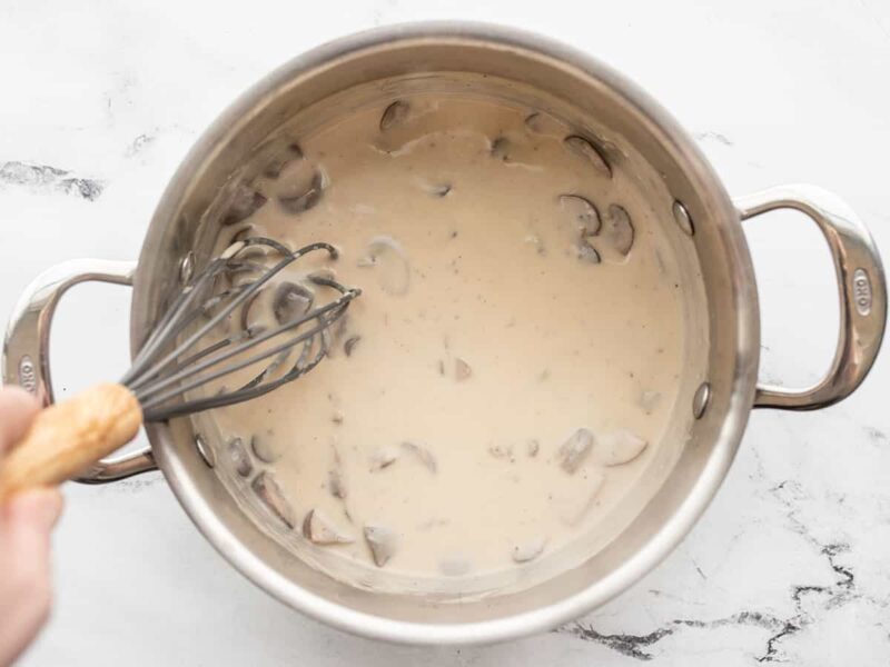 finished mushroom cream sauce being whisked