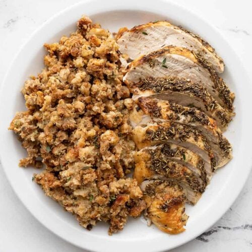 Sliced roasted turkey and stuffing on a plate